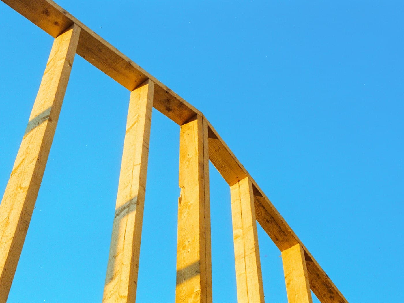 A timber-framed house structure against a clear sky (stock photograph, not a Craft Homes project)